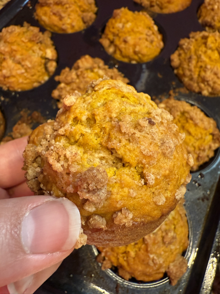 holding whole sourdough pumpkin muffin